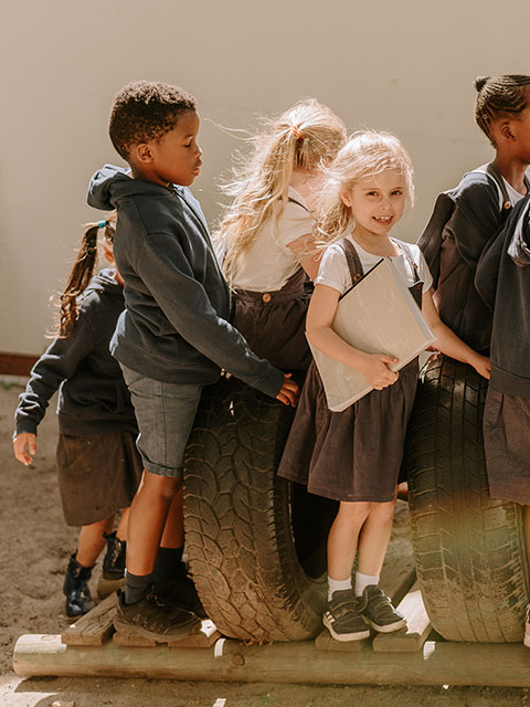 Children playing together at Three Peaks School